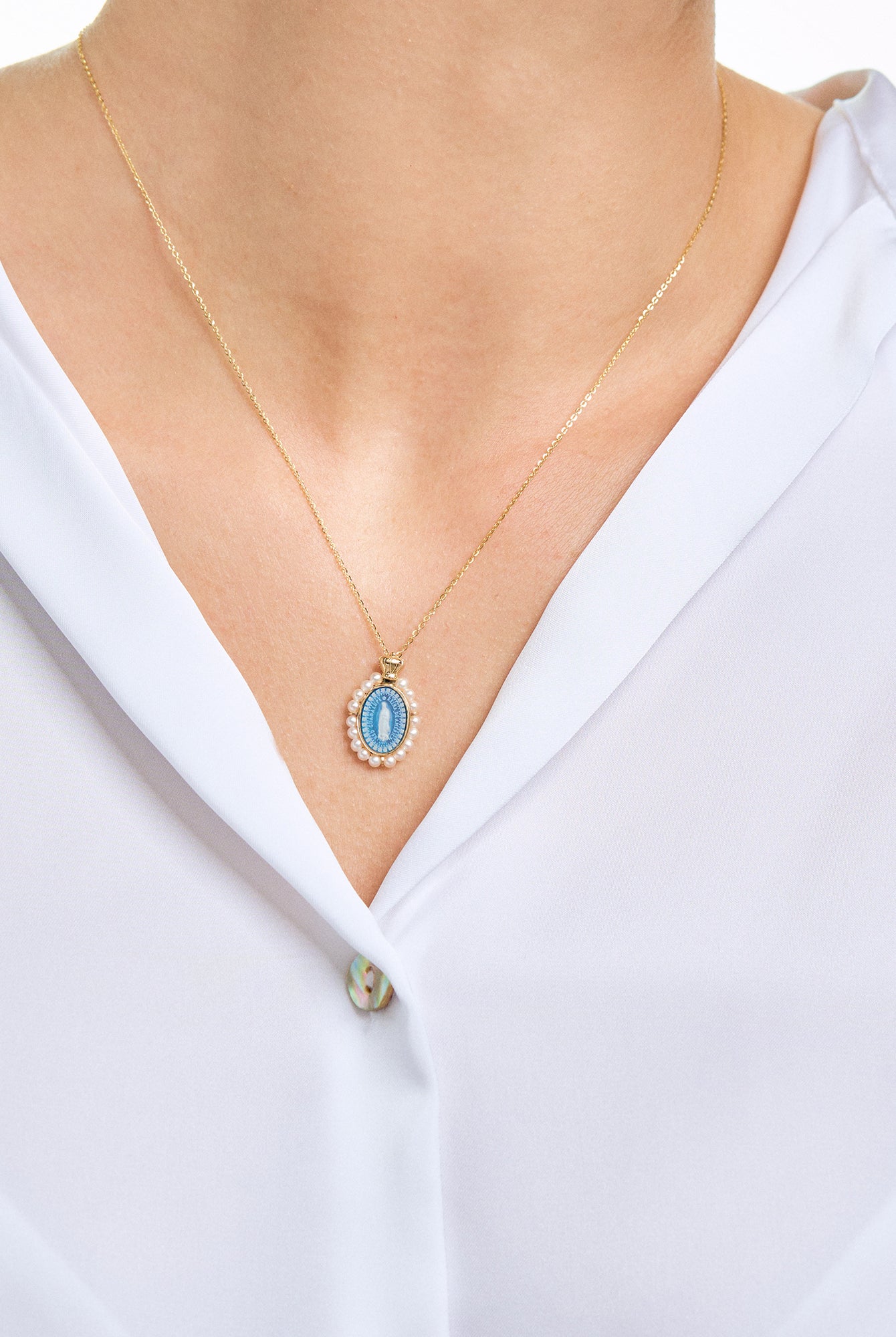 Model wearing a virgen de guadalupe cameo necklace in 14k yellow gold
