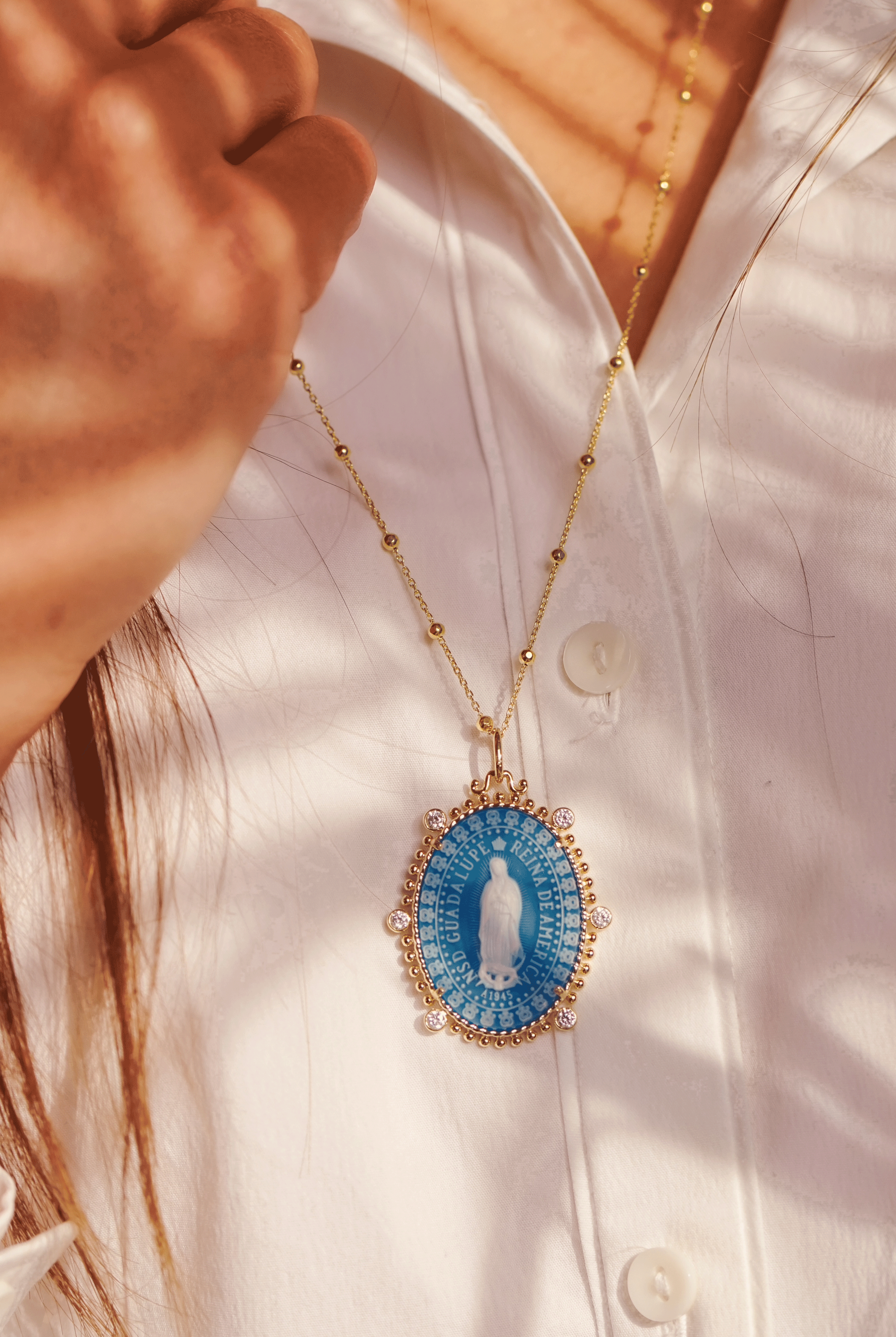 model wearing the virgin of Guadalupe medallion by Frank Ronay