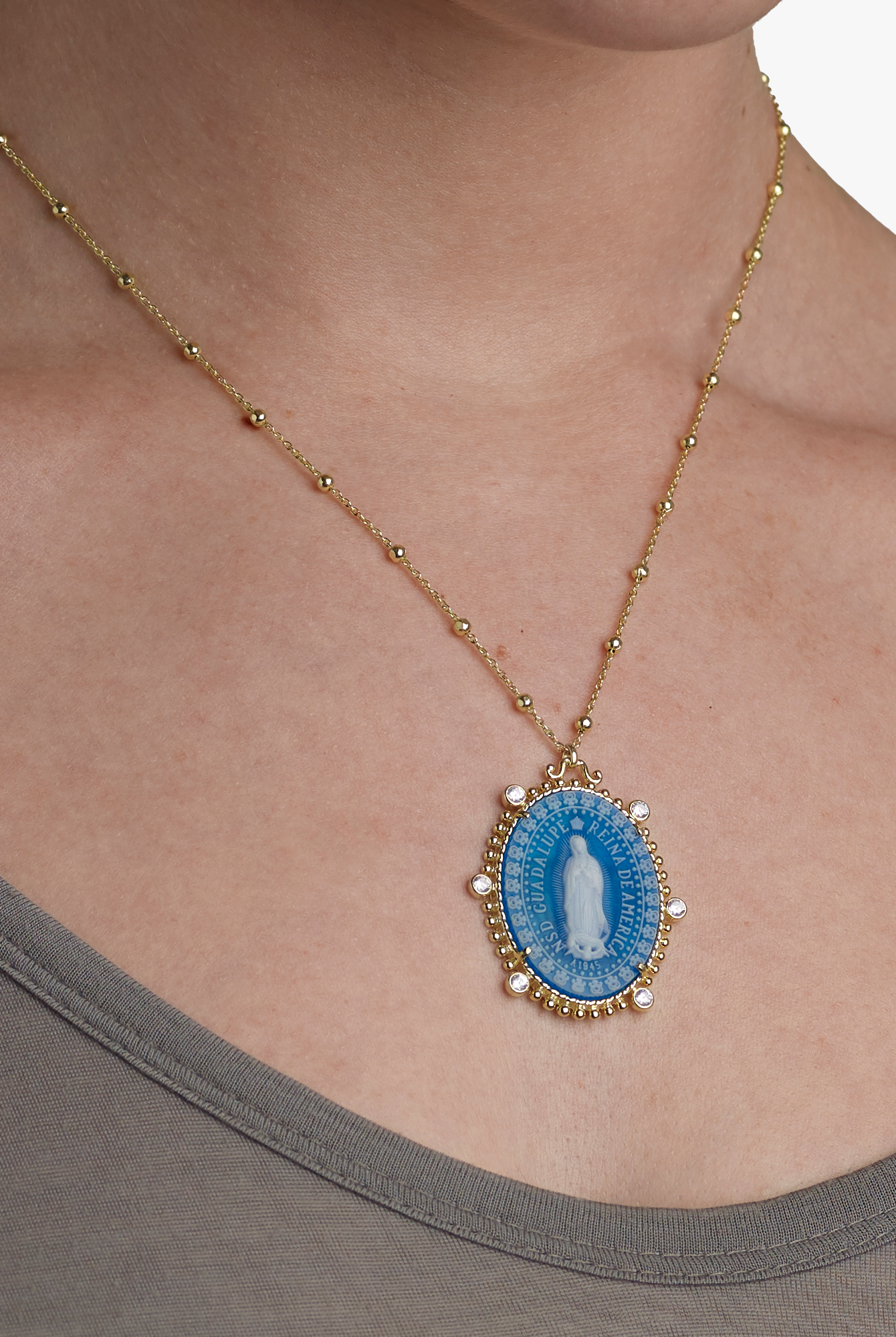 chest model wearing the virgin of Guadalupe medallion