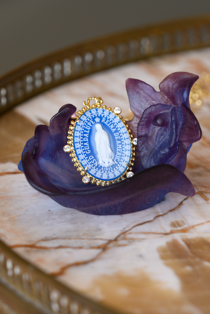 Reina medallion pendant necklace depicting the virgin of Guadalupe on a flower