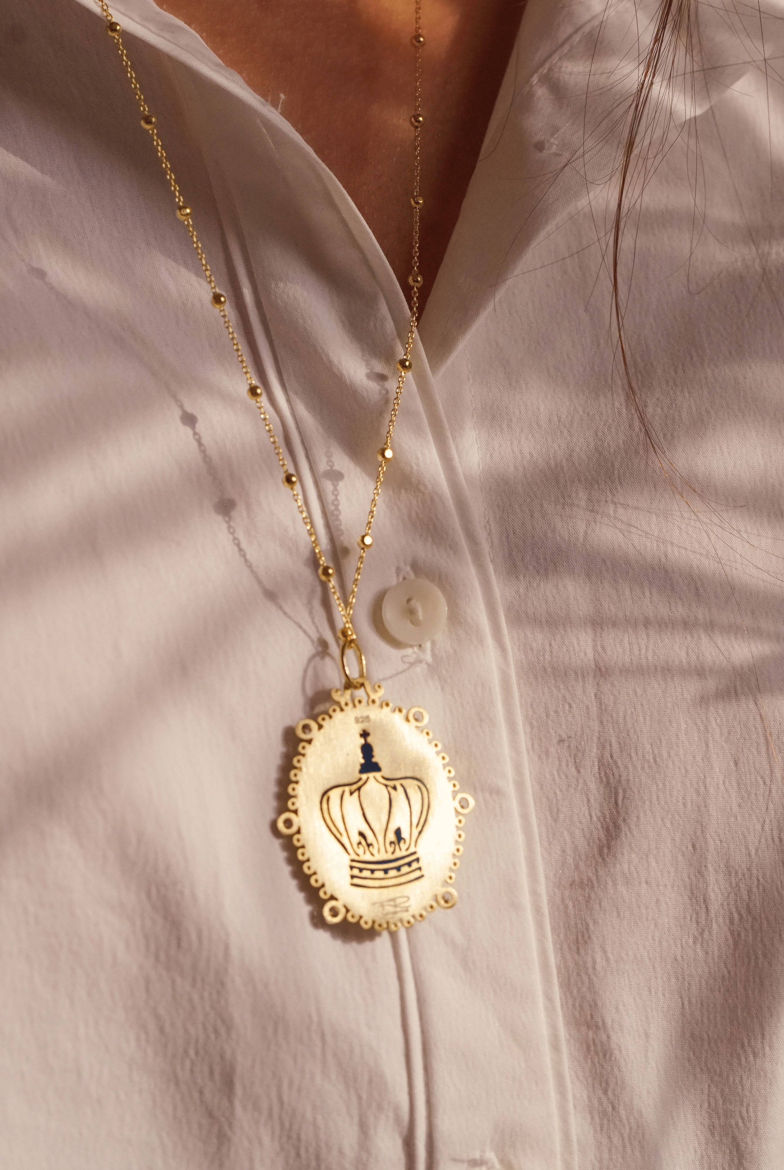 backside of the virgin of Guadalupe medallion