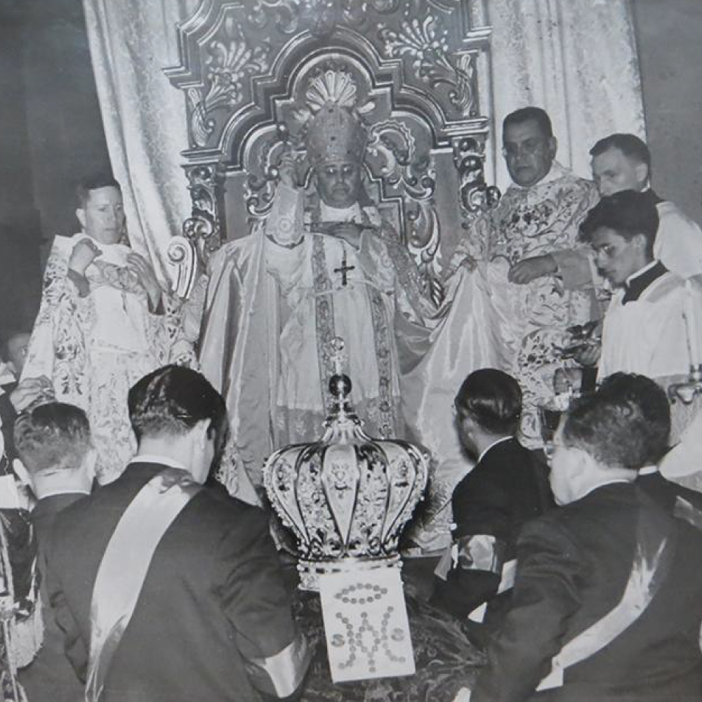 Men gathered at the basilica in Mexico City around the gold crown made by Frank Ronay in honor of the virgin of guadalupe