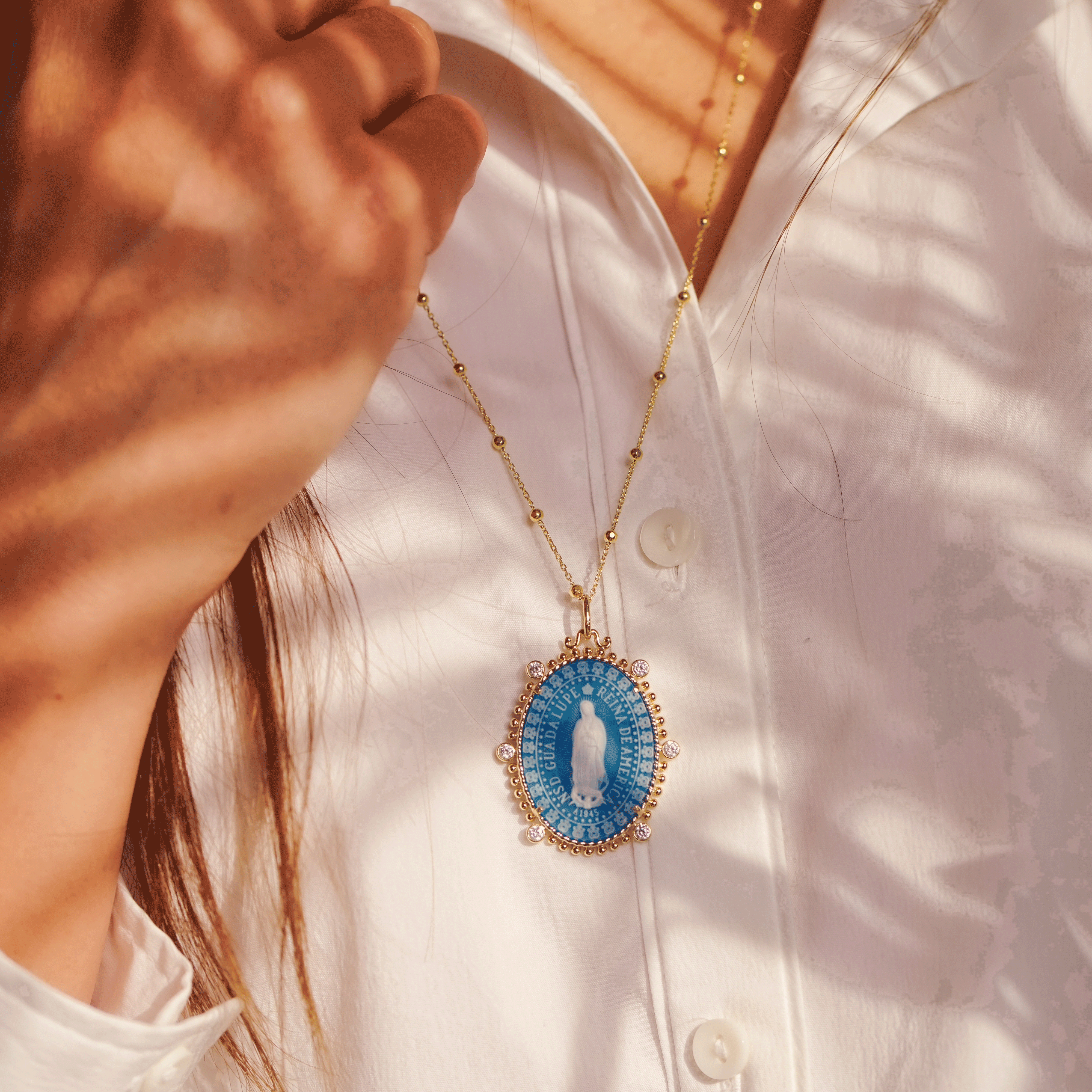 model wearing the virgin of Guadalupe medallion by Frank Ronay