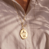 backside of the virgin of Guadalupe medallion